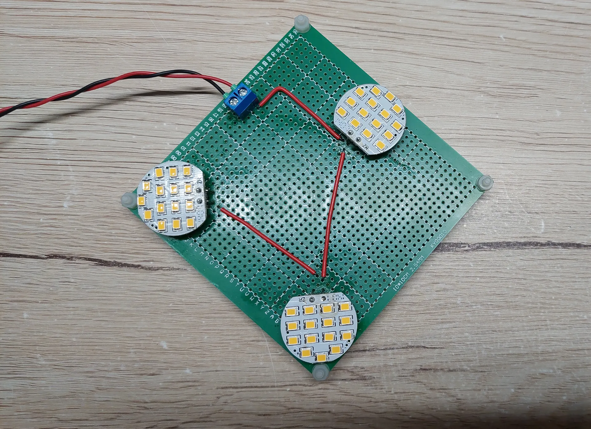 A custom-made LED lamp for the light box, with three LED modules soldered onto a universal PCB.