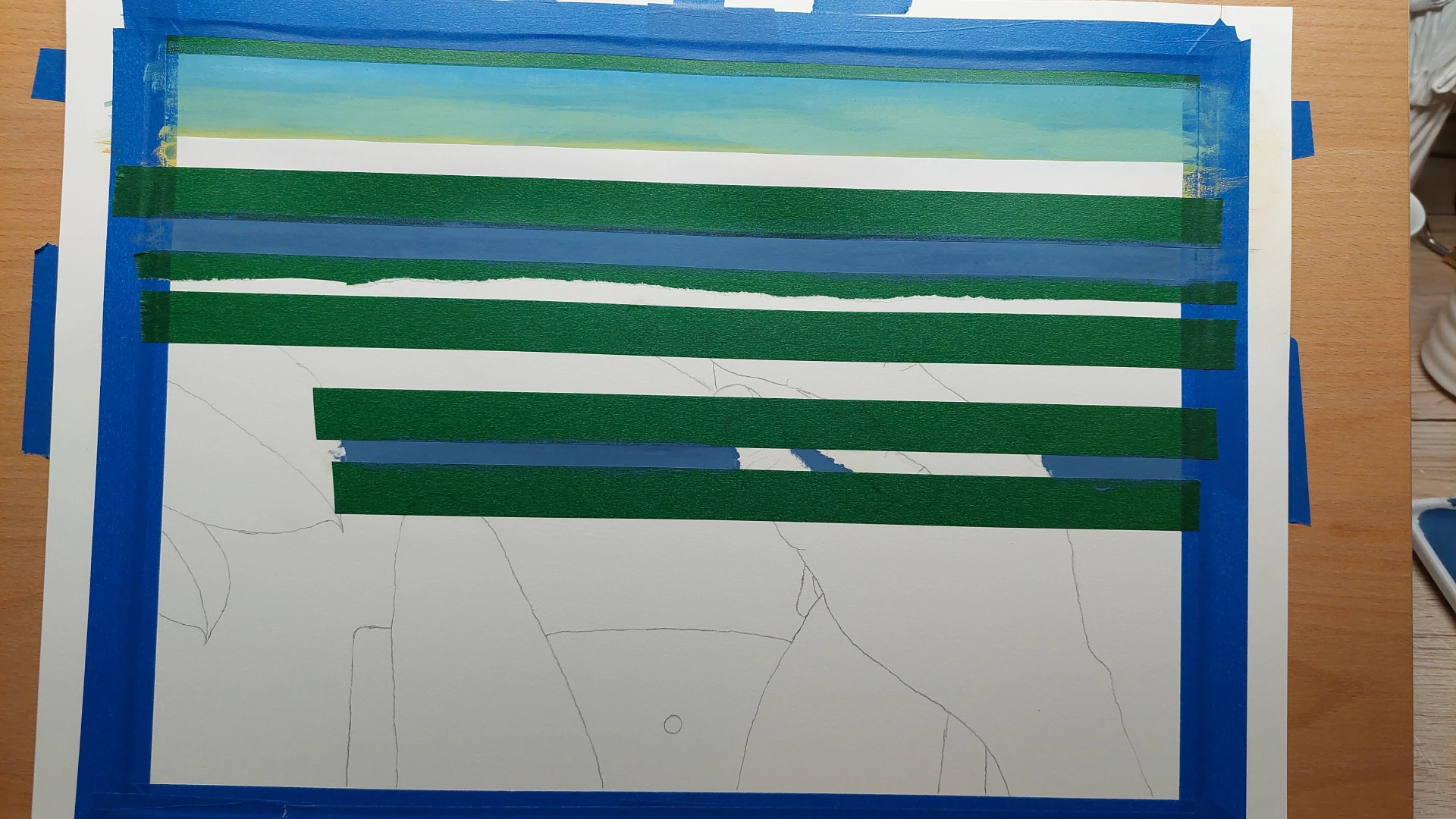 Washi tape applied to the paper, masking the lines between the sky, water, and barrier.