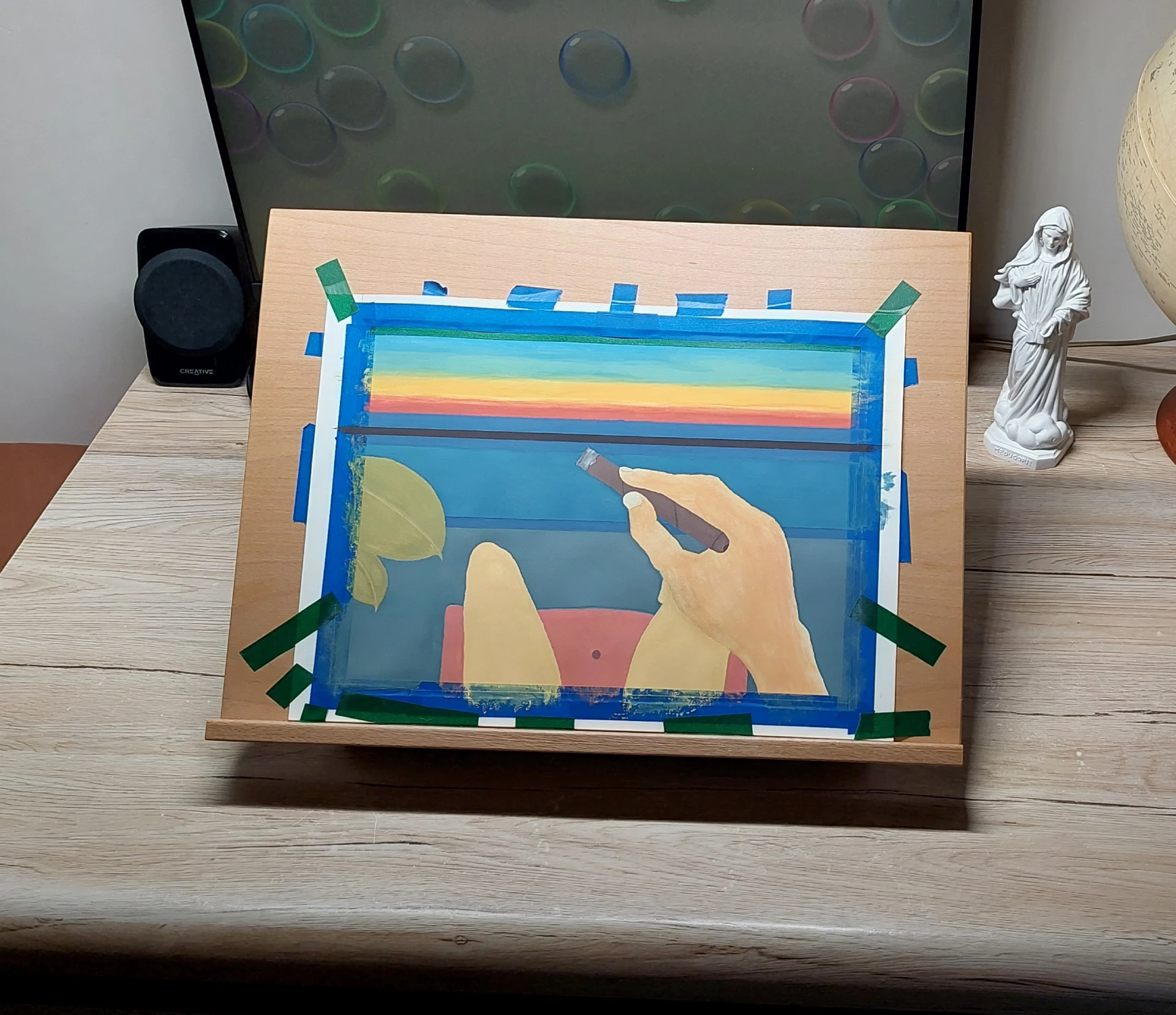 The painting with all elements colored in, still masked with washi tape.