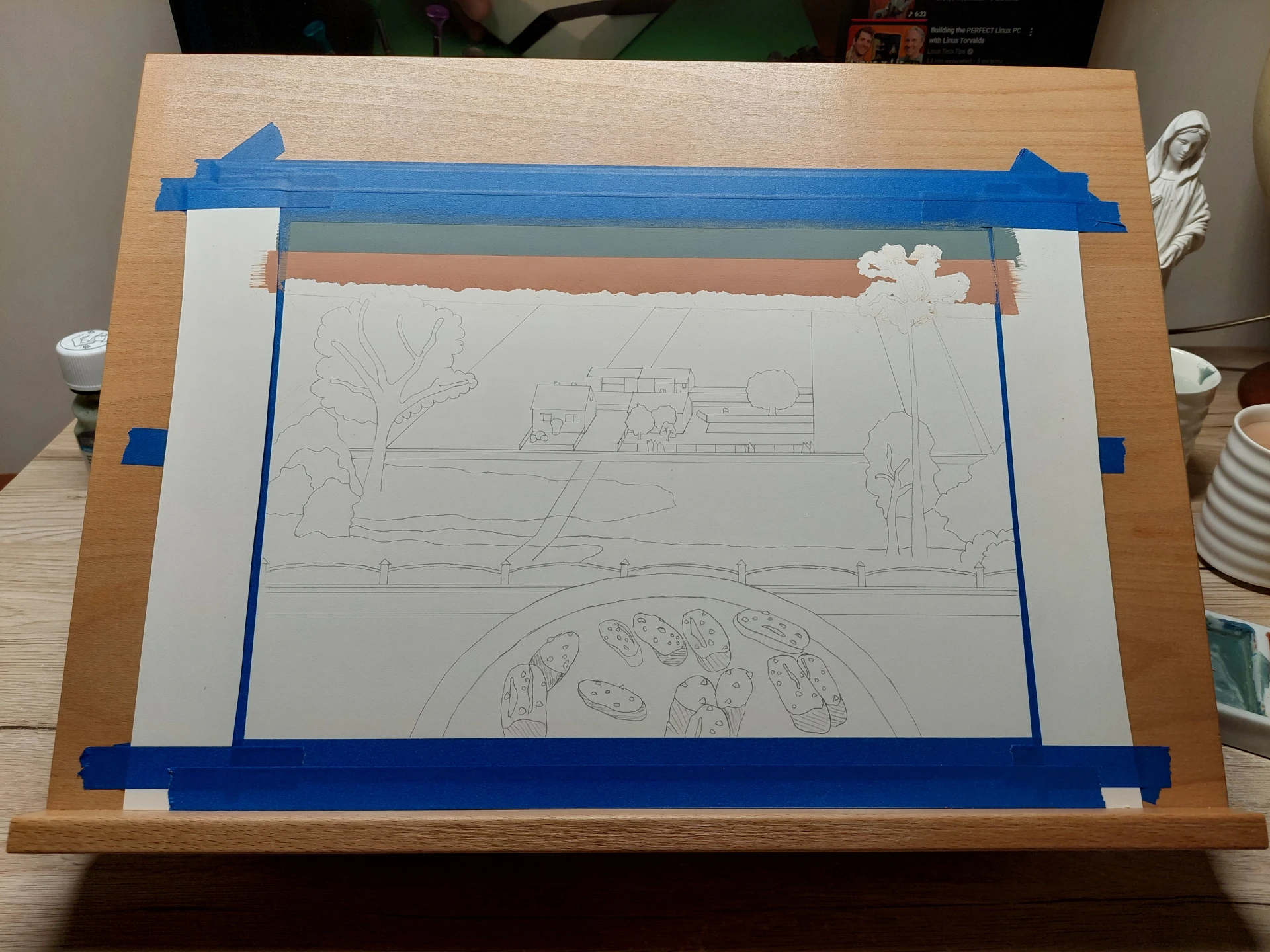 First layers of gouache paint showing the blue sky and a wide cultivated field.