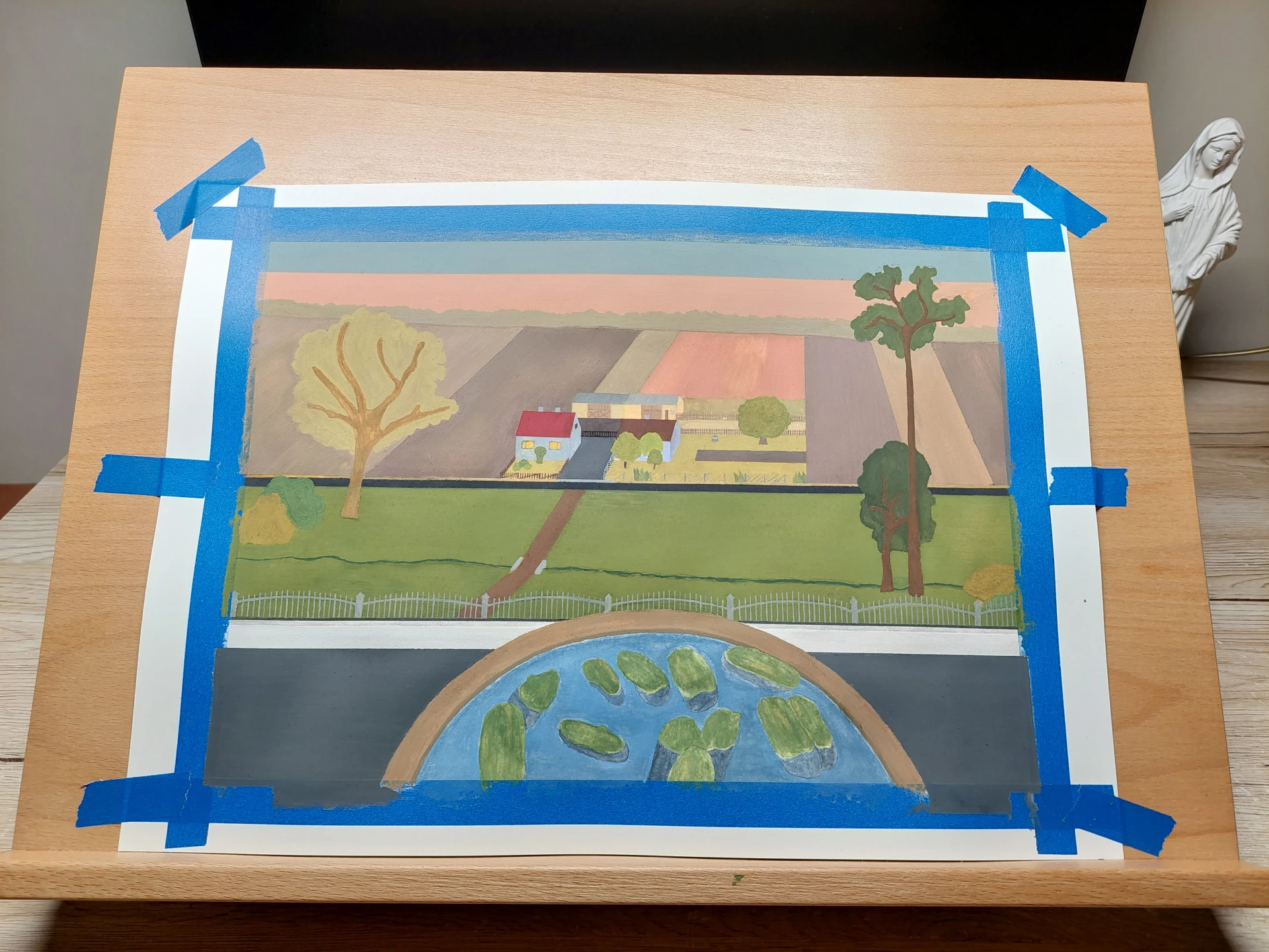 The completed gouache landscape painting still featuring the masking tape border.